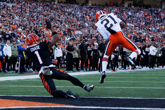 Denzel Ward jumps to intercept a pass with Cincinnati Bengals wide receiver Ja'Marr Chase behind him